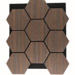 Wooden hexagonal tiles with visible grain arranged in a honeycomb pattern on a black backing area.