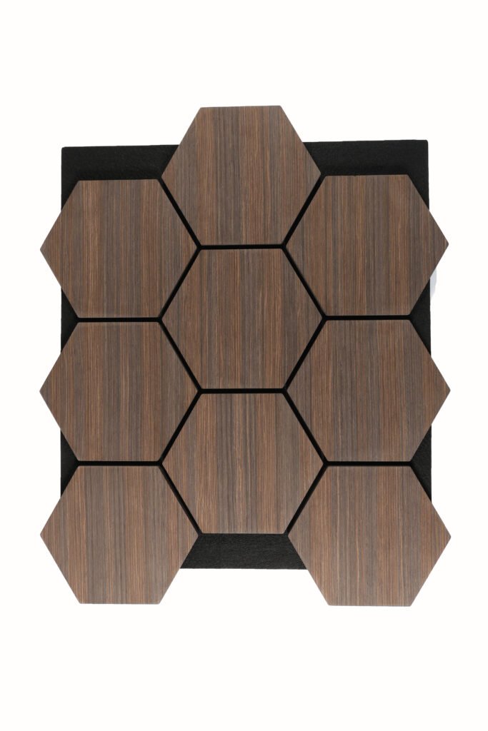 Wooden hexagonal tiles with visible grain arranged in a honeycomb pattern on a black backing area.